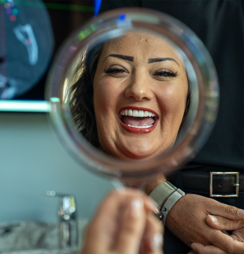 patient smiling brightly after just finishing up their dental procedure