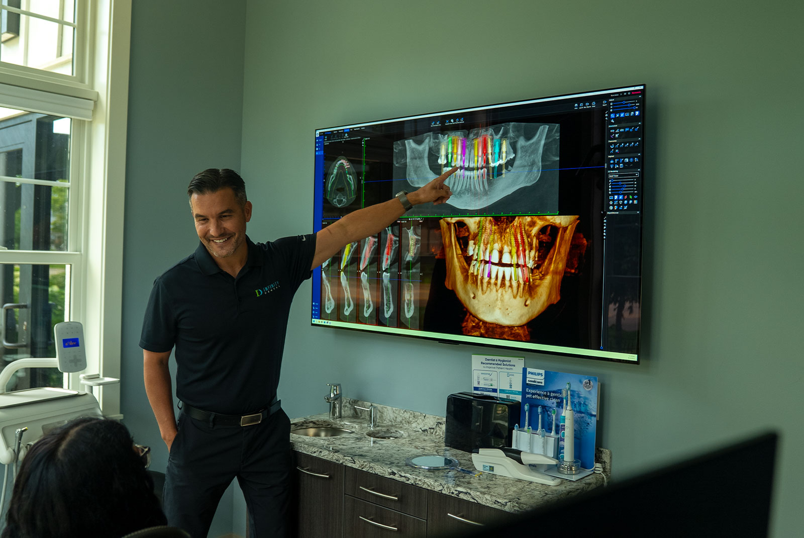 Doctor going over dental procedure information within the dental center