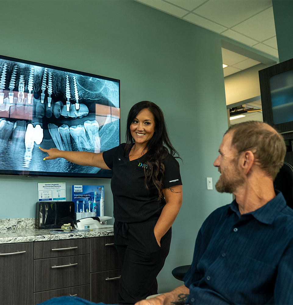staff member going over dental procedure information within the dental center