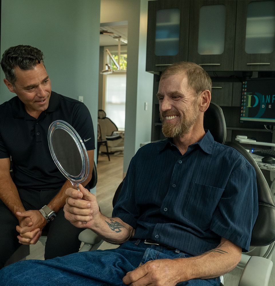 patient smiling brightly after their dental implant procedure within the dental center