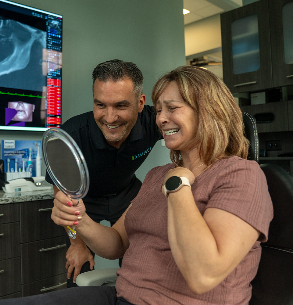 patient and doctor both smiling brightly after patient's dental procedure
