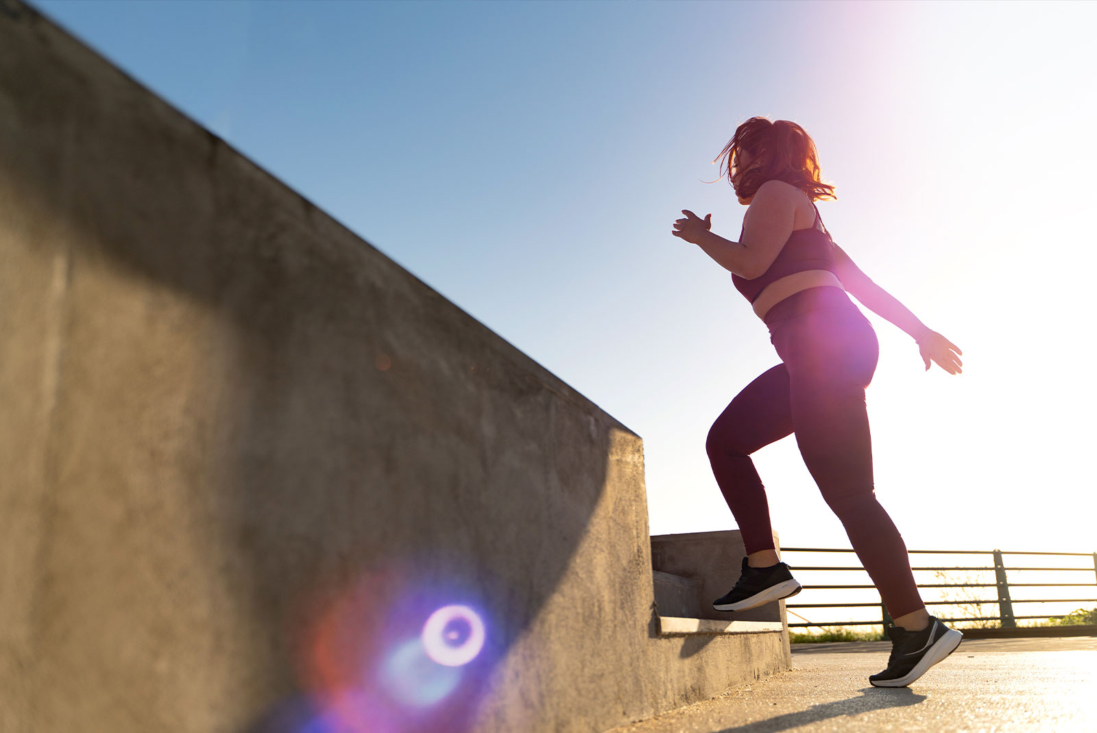 women working out and going up a set up stairs while jogging